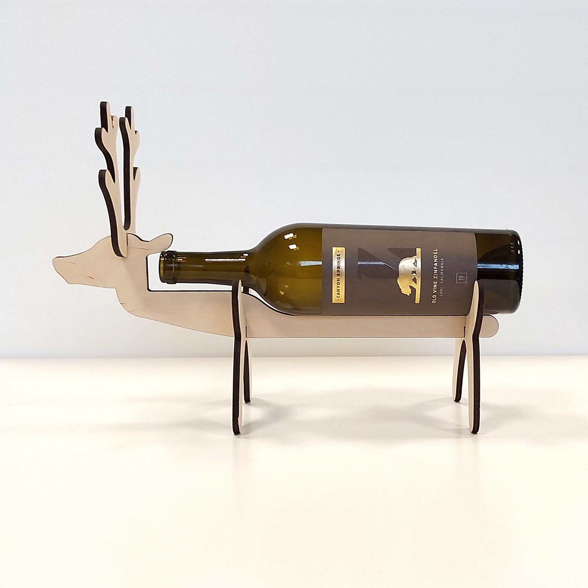 https://rockhopper-labs.com/cdn/shop/products/ReindeerWineBottleHolder-withbottle-side.jpg?v=1662564048&width=1946